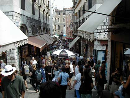 A huge and busy market next to the grand canal in venice.